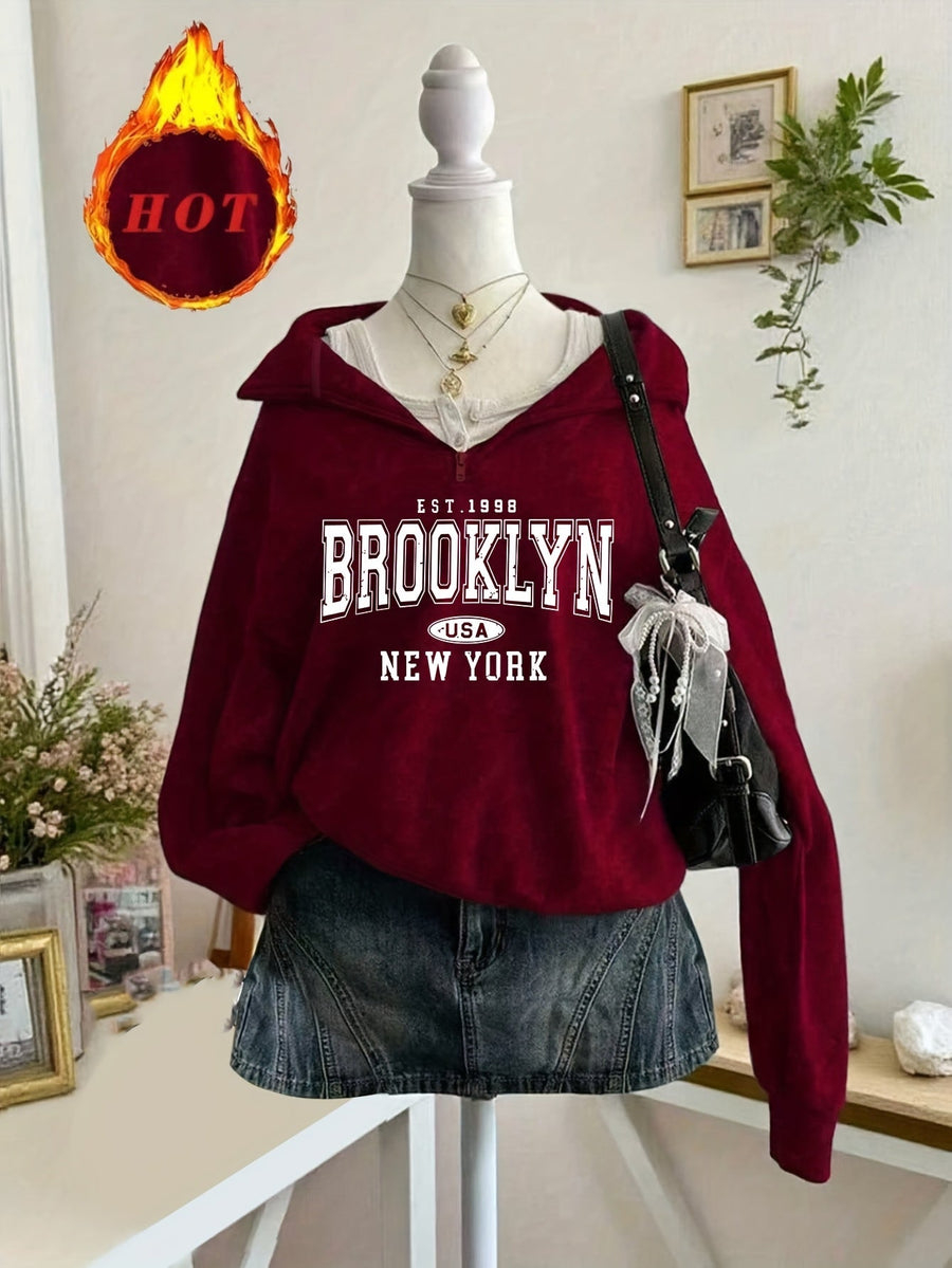 Kort sweatshirt med dragkedja, tryck och halvhög krage i mjukt material
