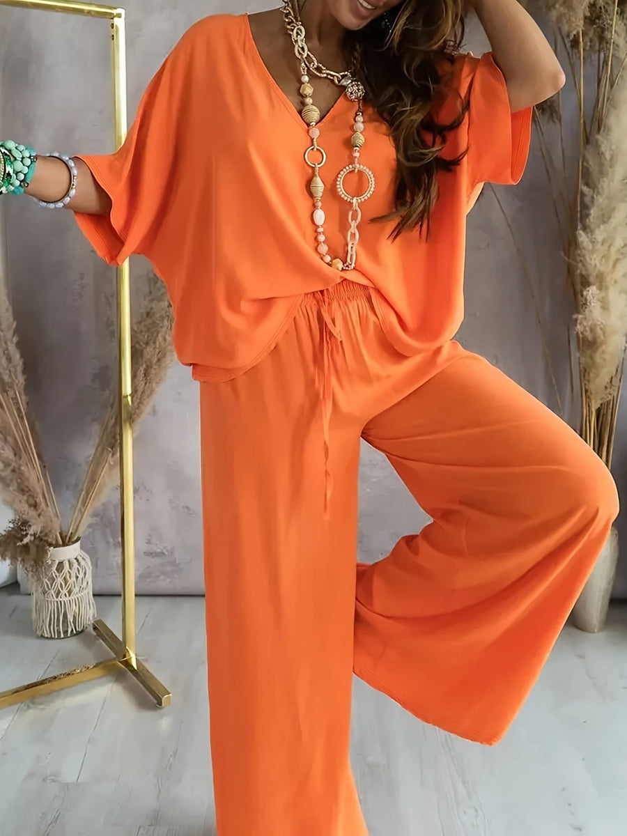 Dam Jumpsuit med V-ringning och Vida Ben – Avslappnad Sommarstil för Fritid och Semester