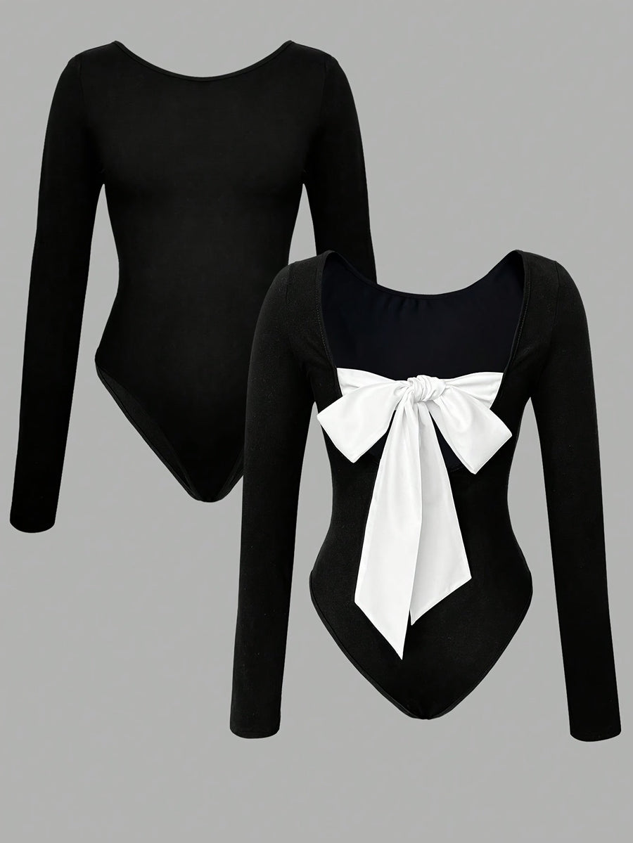 Svart långärmad bodysuit med vit rosett, öppen rygg