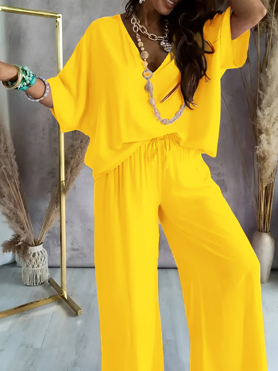 Dam Jumpsuit med V-ringning och Vida Ben – Avslappnad Sommarstil för Fritid och Semester