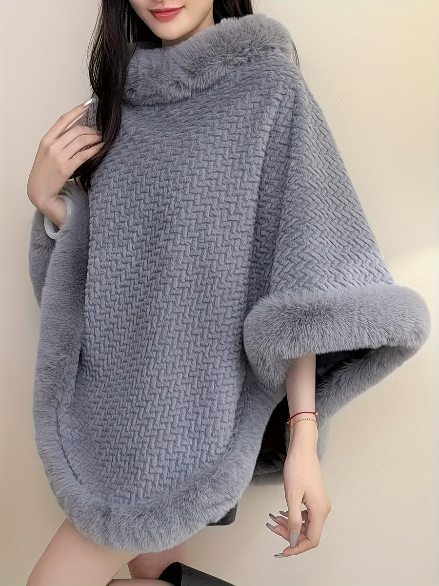 Varm mönstrad poncho med fuskpälsdetaljer runt hals och nederkant