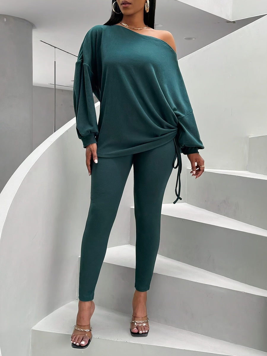 Damsset mörkgrönt med off shoulder-tröja och leggings