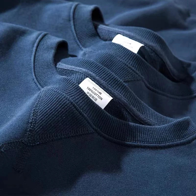 Unisex sweatshirt med rund hals, enfärgad design och ribbade muddar