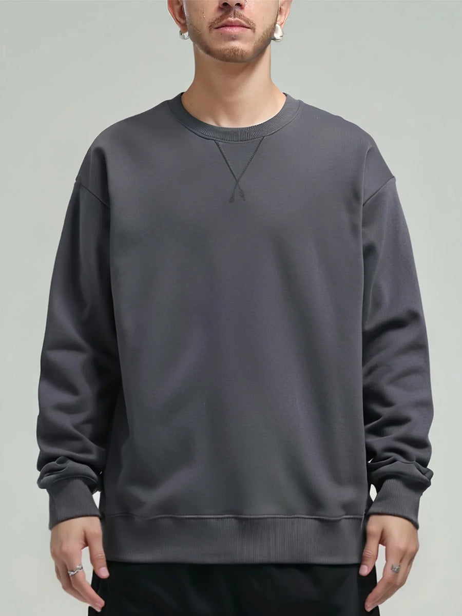 Unisex sweatshirt med rund hals, enfärgad design och ribbade muddar