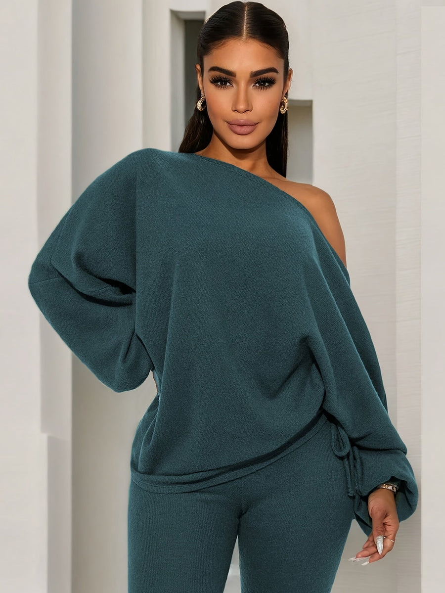 Damsset mörkgrönt med off shoulder-tröja och leggings