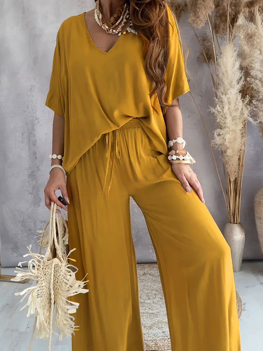 Dam Jumpsuit med V-ringning och Vida Ben – Avslappnad Sommarstil för Fritid och Semester