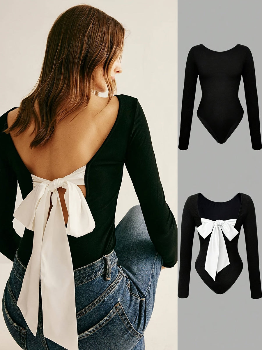 Svart långärmad bodysuit med vit rosett, öppen rygg