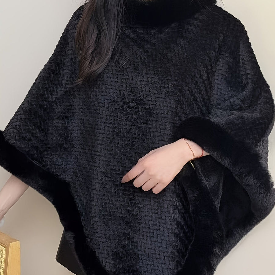 Varm mönstrad poncho med fuskpälsdetaljer runt hals och nederkant