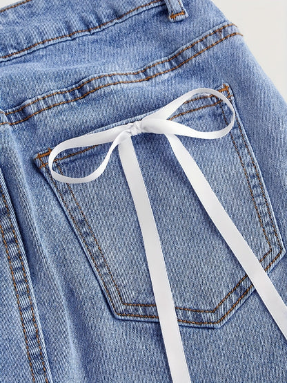 Dam Kjol Mini Elegant Denim Stil för Sommar med Fickdetalj och Dekorativa Rosetter