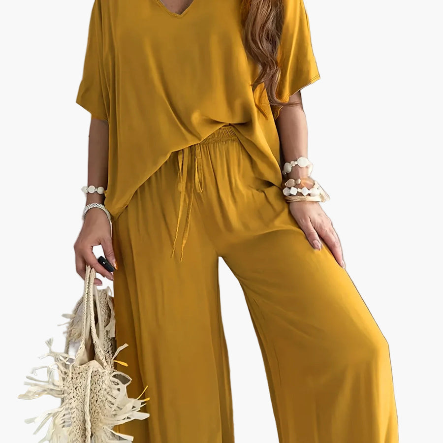 Dam Jumpsuit med V-ringning och Vida Ben – Avslappnad Sommarstil för Fritid och Semester