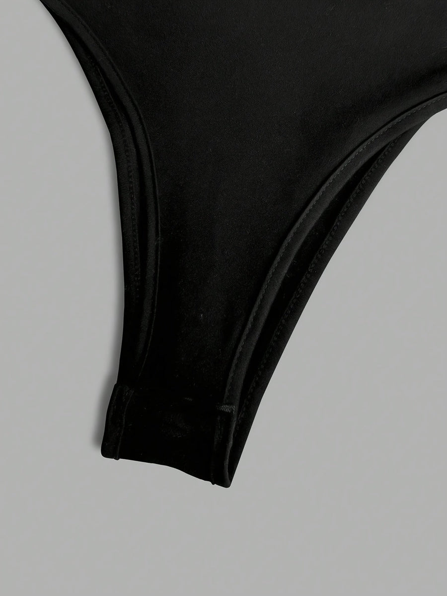 Svart långärmad bodysuit med vit rosett, öppen rygg
