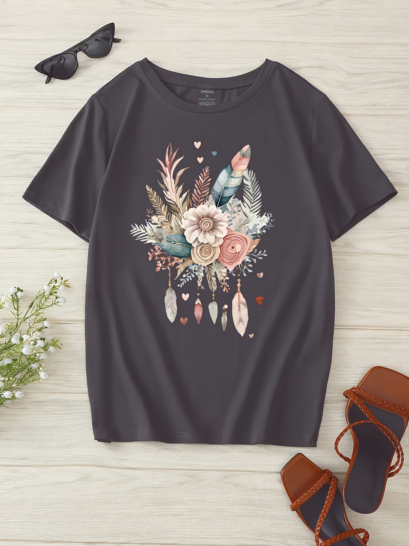 Dam T-shirt med blommigt och fjädertryck, avslappnad stil, perfekt för vardagsbruk