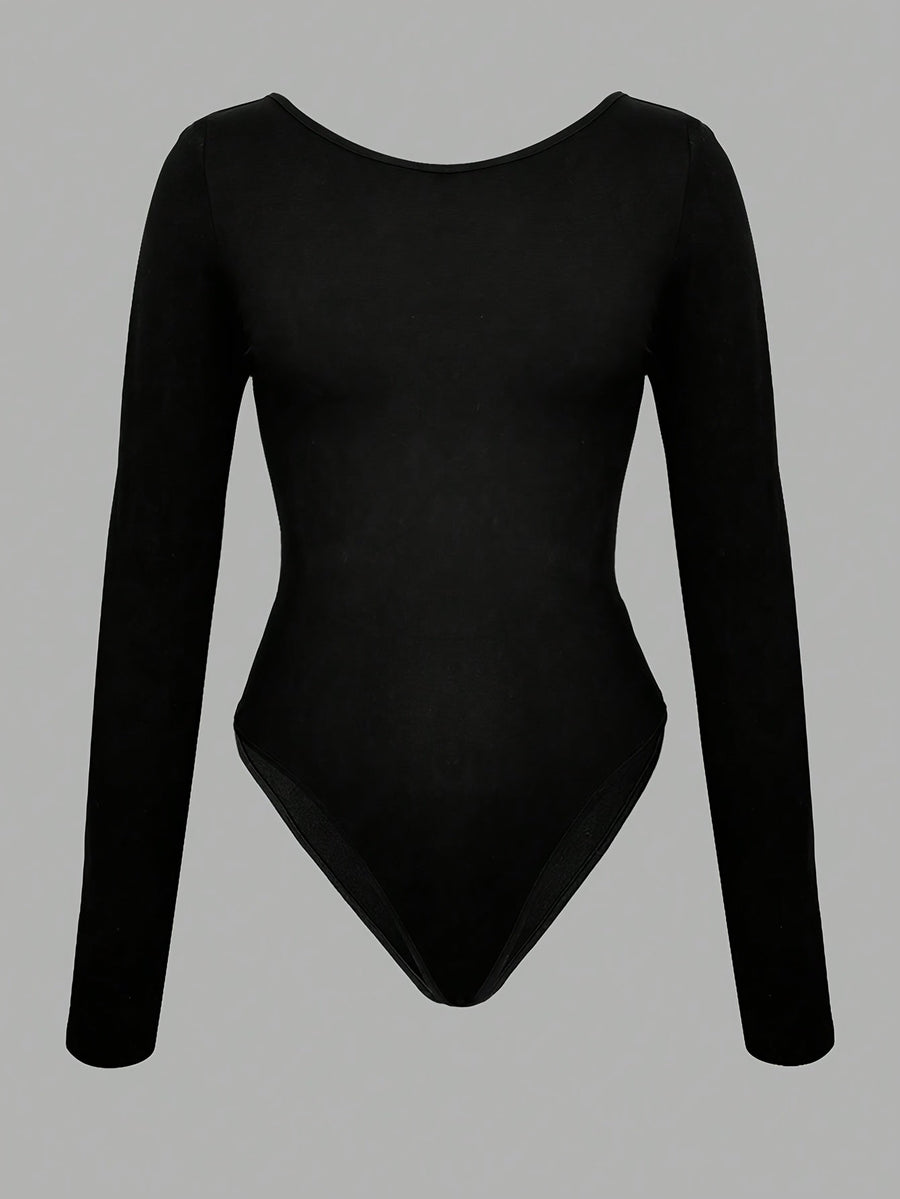 Svart långärmad bodysuit med vit rosett, öppen rygg