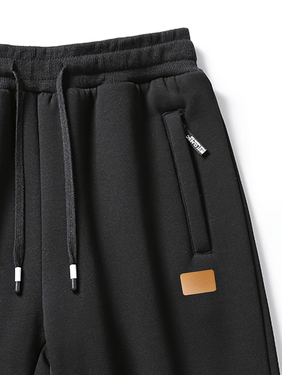Svarta fodrade sweatpants med dragsko och muddar för herr