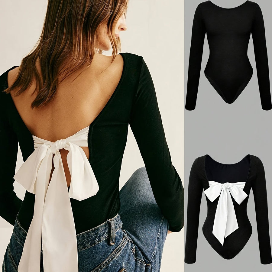 Svart långärmad bodysuit med vit rosett, öppen rygg